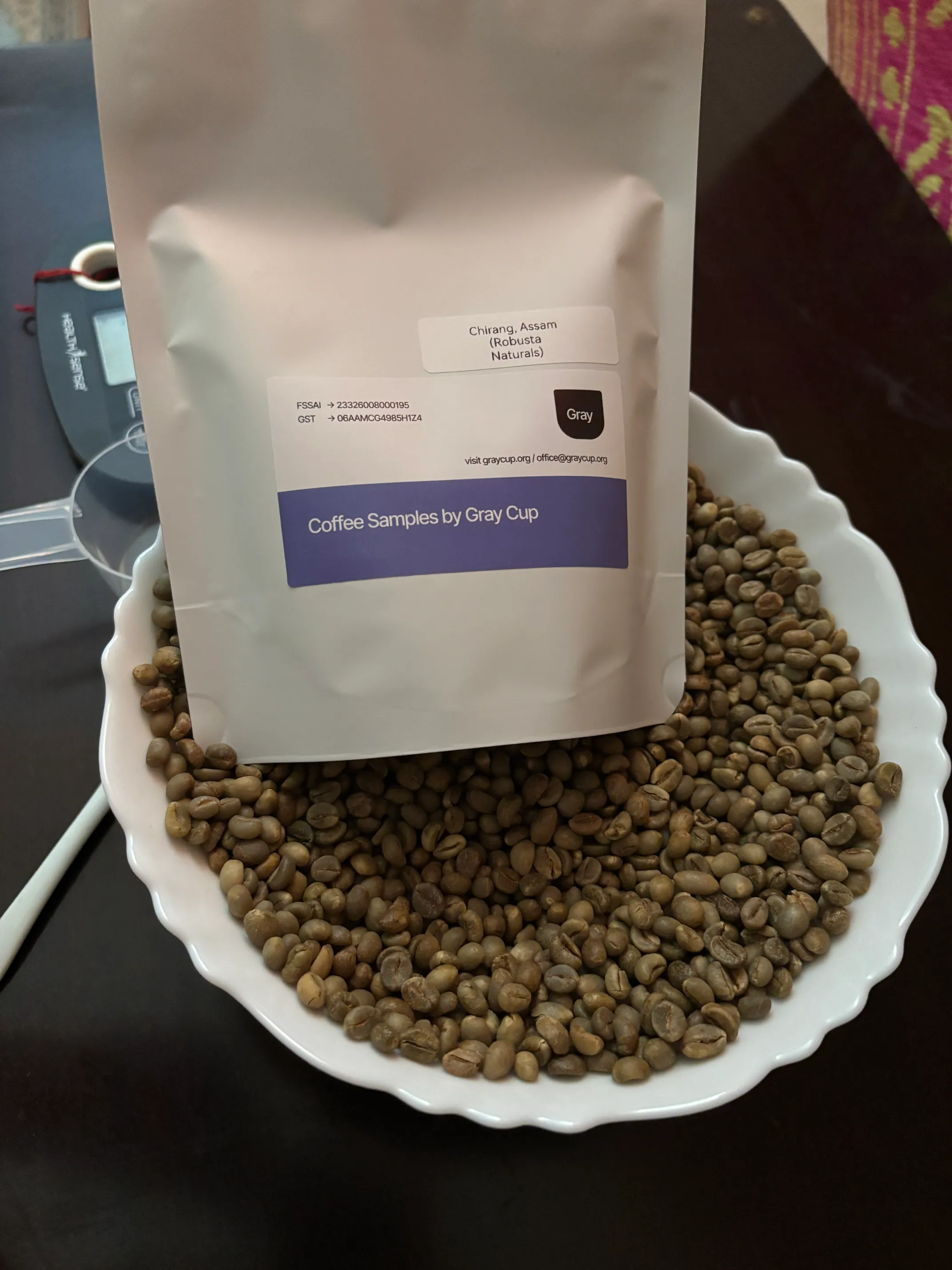 A labelled sample bag of Chirang, Assam Robusta Naturals green coffee beans